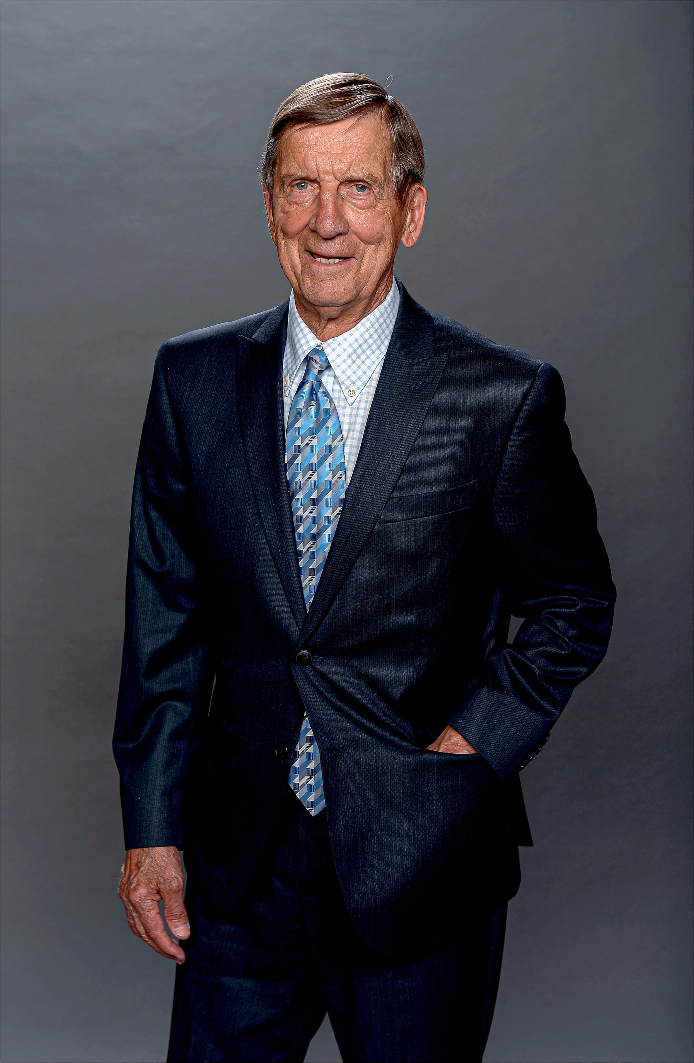 Ted Lindsay wearing a sharp navy suit and baby blue tie